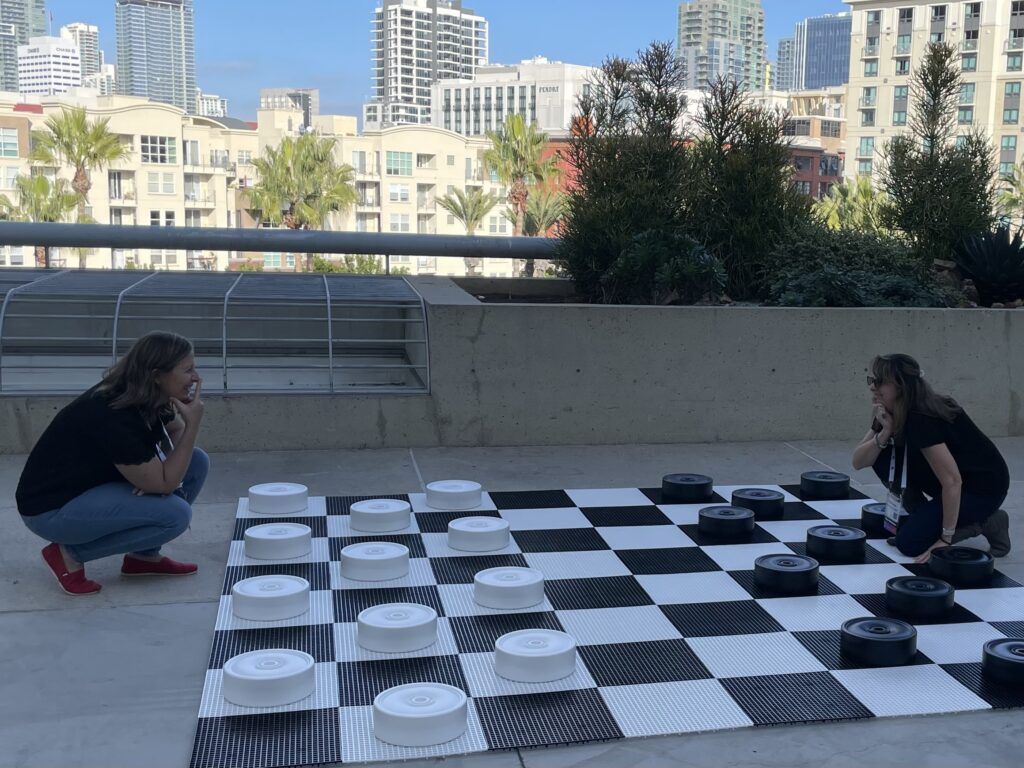 Becky Bosley and Robin Tuohy playing life-sized checkers.